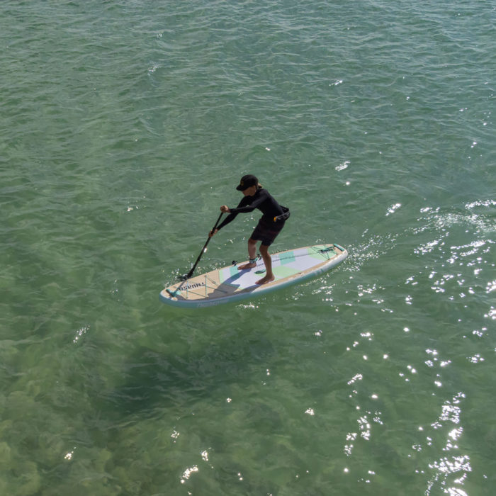 boy paddling on thurso surf adept paddle board in ocean