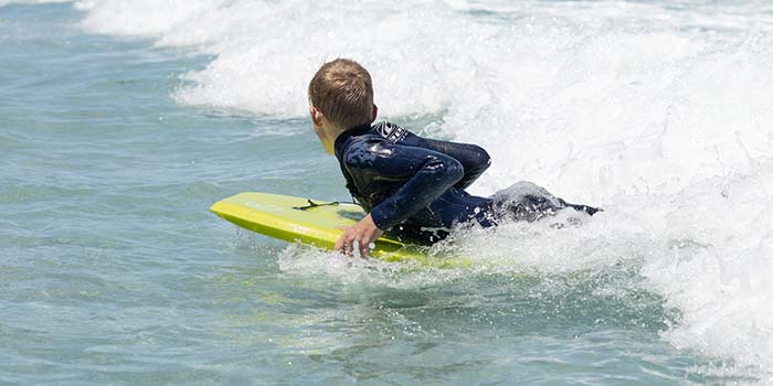 a chlid surfing with thurso surf 37 in eps boogie board