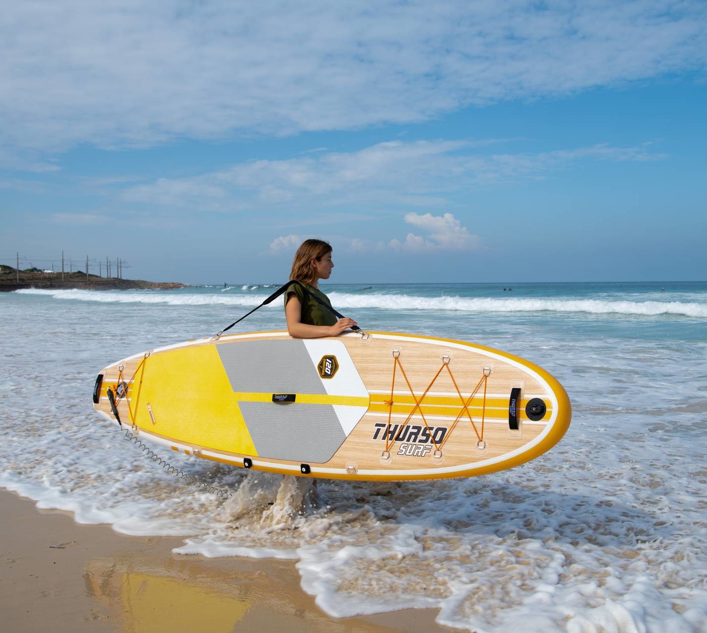 Lady holding surfboard in his hand