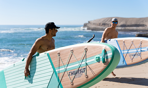 two man holding the thurso surf new waterwalker all around sup