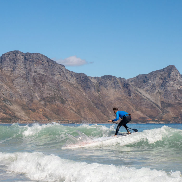 touring sup board thurso surf expedition man surfing waves
